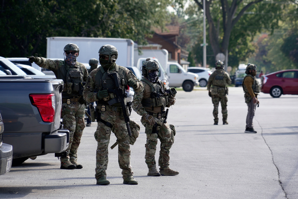 Federal agents stand guard as a planned protest starts outside of an immigration facility in Broadview, Ill. Friday, Sept. 12, 2025. (AP Photo/Laura Bargfeld)