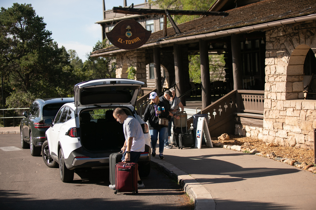 Tourists check out of the El Tovar Hotel as lodging along the rim of the canyon was shut down due to flooding, Monday, Aug. 31, 2026 at Grand Canyon National Park, Ariz. (AP Photo/Josh Biggs)