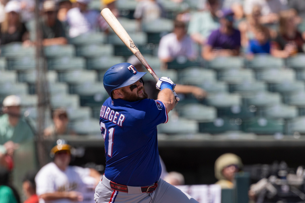 Texas Rangers' Jake Burger hits a home run during the second inning of a baseball game against the Athletics, Sunday, Aug. 16, 2026, in West Sacramento, Calif. (AP Photo/Sara Nevis)