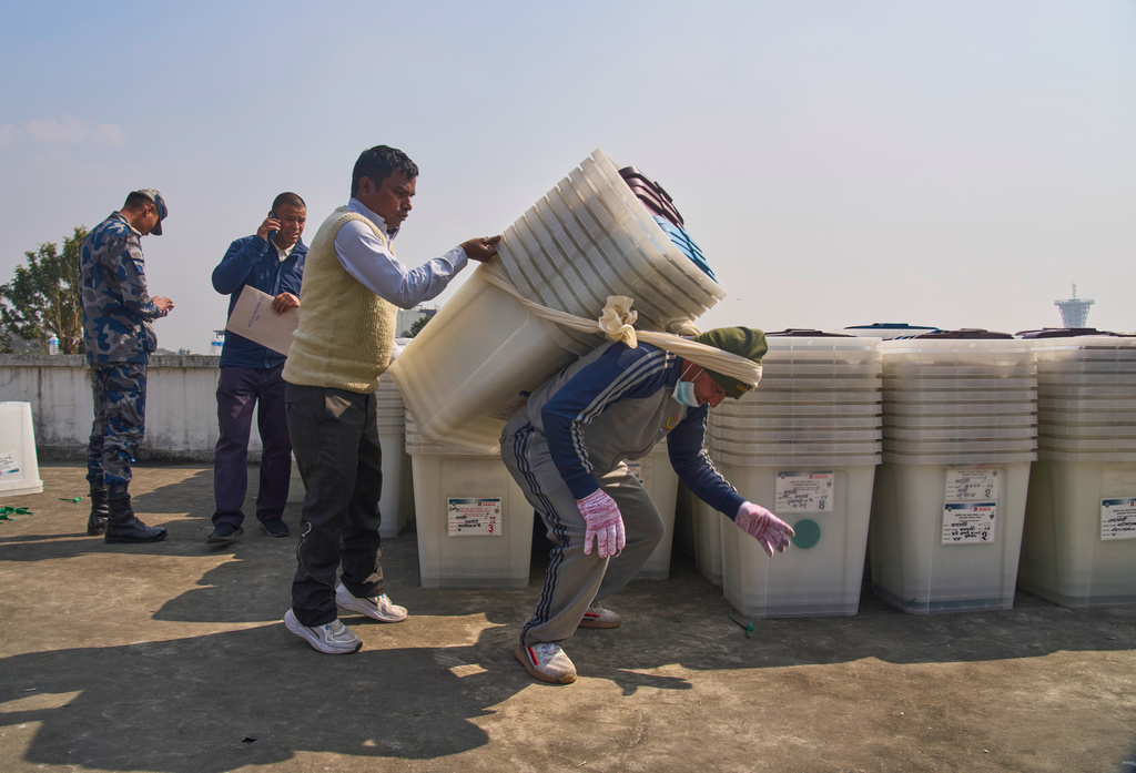 A laborer carries ballot boxes to a vehicle for distribution across the country ahead of the general election in Kathmandu, Nepal, Feb. 8, 2026. (AP Photo/Niranjan Shrestha)