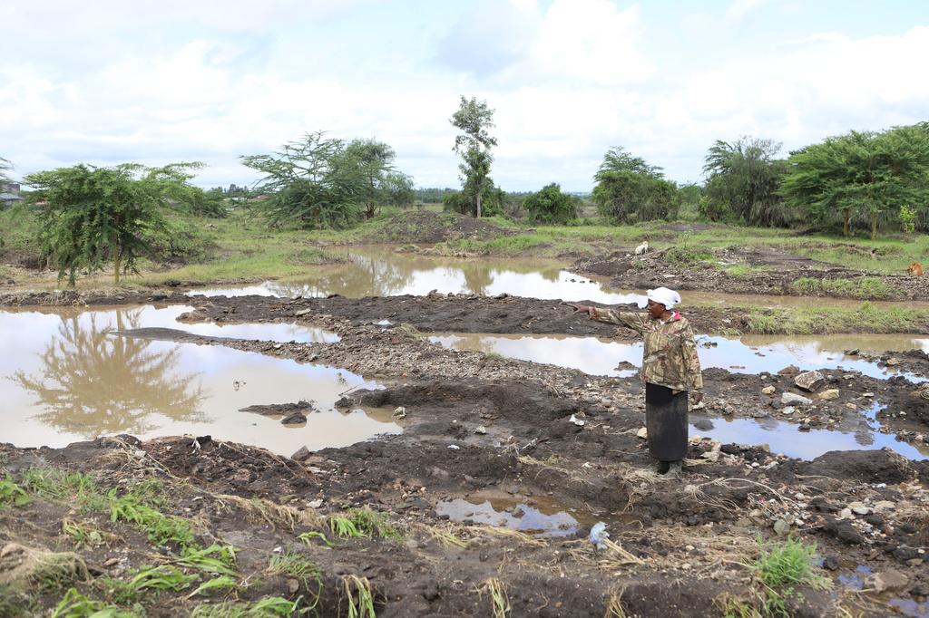 FILE - Martha Waema, stands on her farm after it was submerged by weeks of rainfall in Machakos, Kenya, May 8, 2024. (AP Photo/Andrew Kasuku, File)