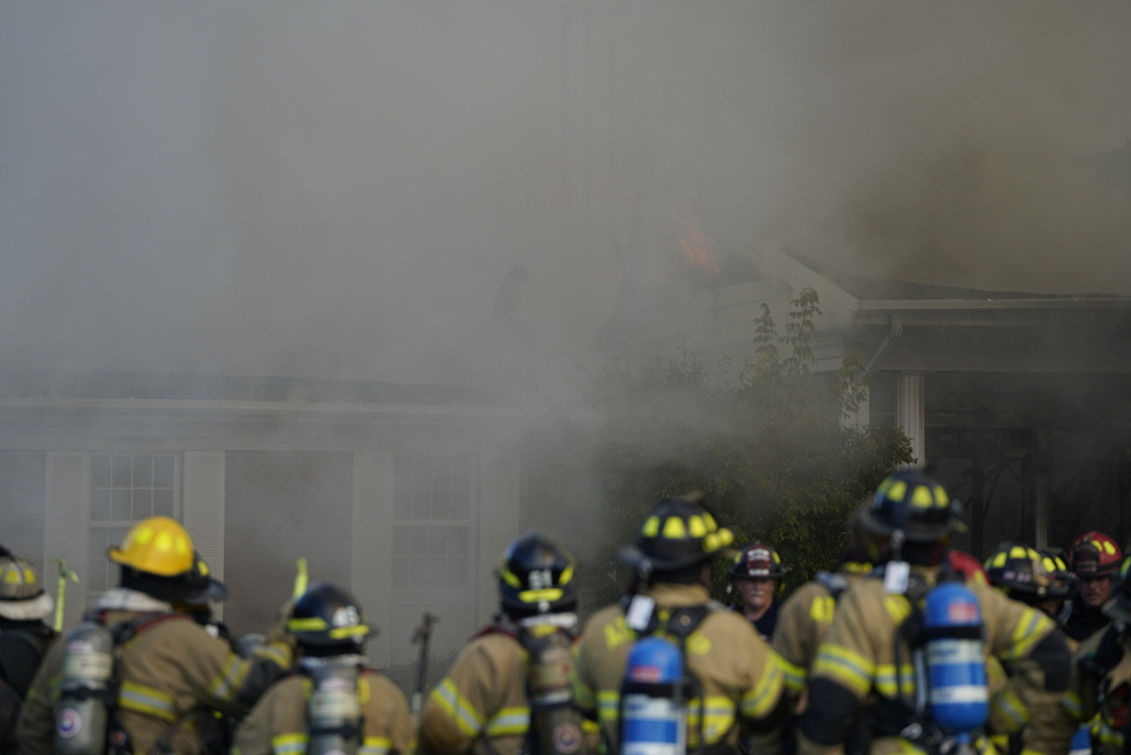 Emergency responders work the scene outside The Church of Jesus Christ of Latter-day Saints following a shooting and fire in Grand Blanc, Mich., Sunday, Sept. 28, 2025. (Lukas Katilius/The Flint Journal via AP)