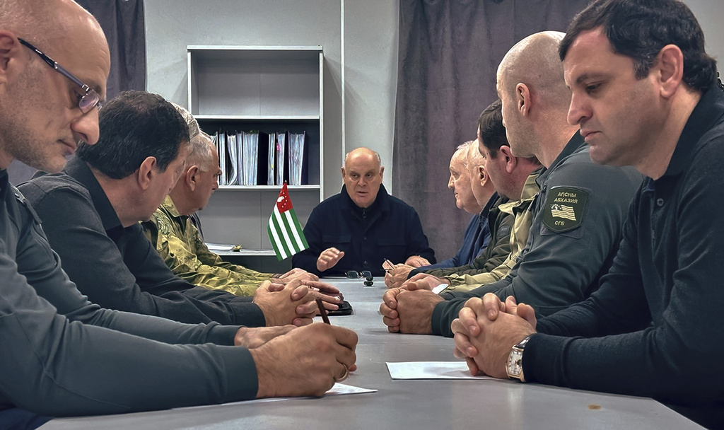 In this photo taken from video released by Information Center of the President of the Republic of Abkhazia on Monday, Nov. 18, 2024, Abkhazian President Aslan Bzhania, center, chairs a Security Council meeting in the village of Tamishi, in Georgia&rsquo;s breakaway province of Abkhazia. (Information Center of the President of the Republic of Abkhazia via AP)