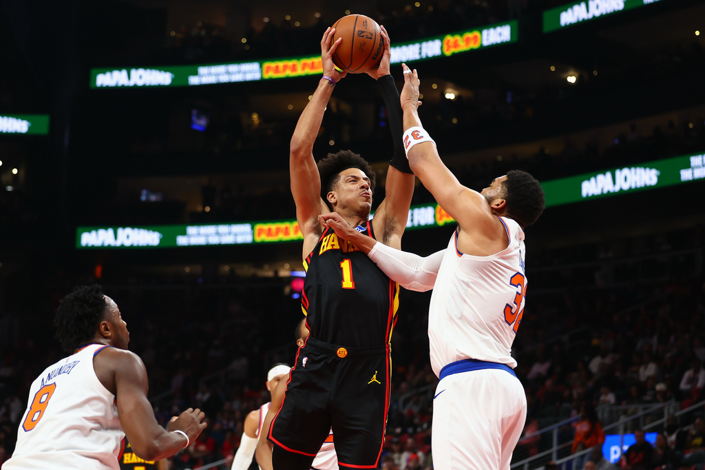 Atlanta Hawks forward Jalen Johnson (1) looks to shoot against New York Knicks center Karl-Anthony Towns, right, during the first half of an NBA basketball game, Monday, April 6, 2026, in Atlanta. (AP Photo/Colin Hubbard)