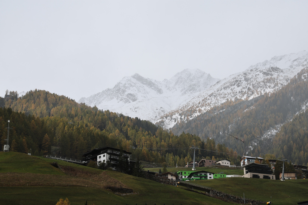 Snow partially blankets the mountain landscape, ahead of Saturday's alpine ski, World Cup opening races, in Soelden, Austria, Friday, Oct. 24, 2025. (AP Photo/Marco Trovati)