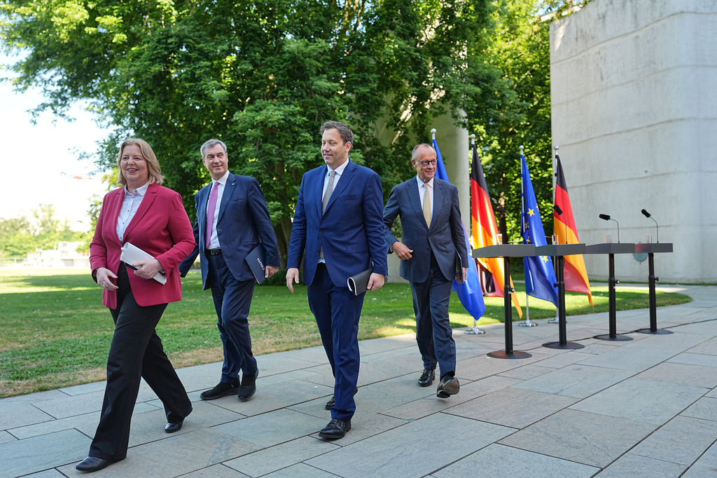 From left, Federal Minister of Labor and Social Affairs Bärbel Bas, Minister-President of Bavaria and CSU Chairman Markus Söder, Federal Minister of Finance Lars Klingbeil and Germany Chancellor Friedrich Merz leave, after a press conference in the garden of the Chancellery following the meeting of the coalition committee, in Berlin, Thursday, July 2, 2026. (Michael Kappeler/dpa via AP)