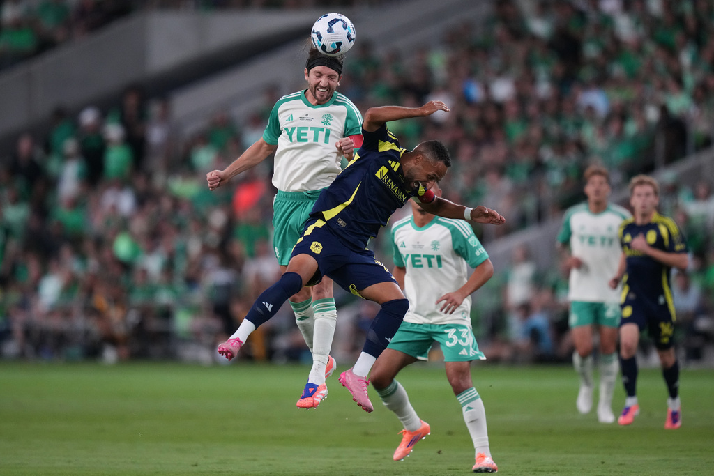 Austin FC midfielder Ilie S·nchez, left, heads the ball past Nashville SC midfielder Hany Mukhtar (10) during the first half of an U.S. Open Cup final soccer match in Austin, Texas, Wednesday, Oct. 1, 2025. (AP Photo/Eric Gay)