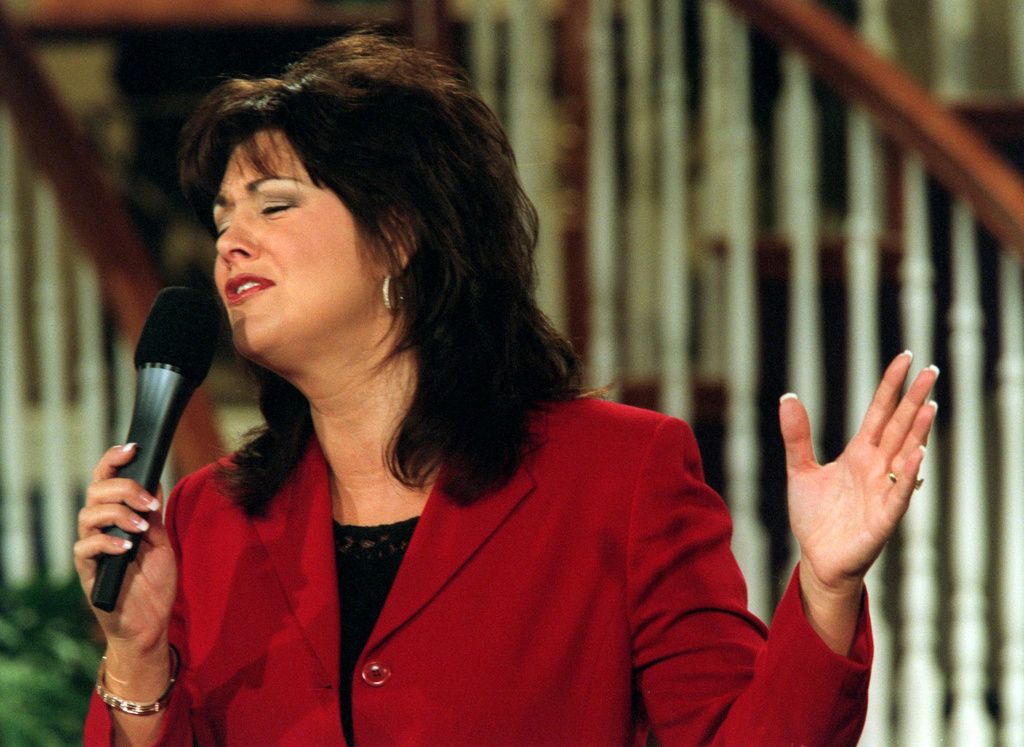 Television evangelistJoni Lamb sings a praise song during 'Celebration', a show that she and her husband Marcus host on the Daystar Network, on July 30, 2001 in Colleyville, Texas. (Lawrence Jenkins/The Dallas Morning News via AP)