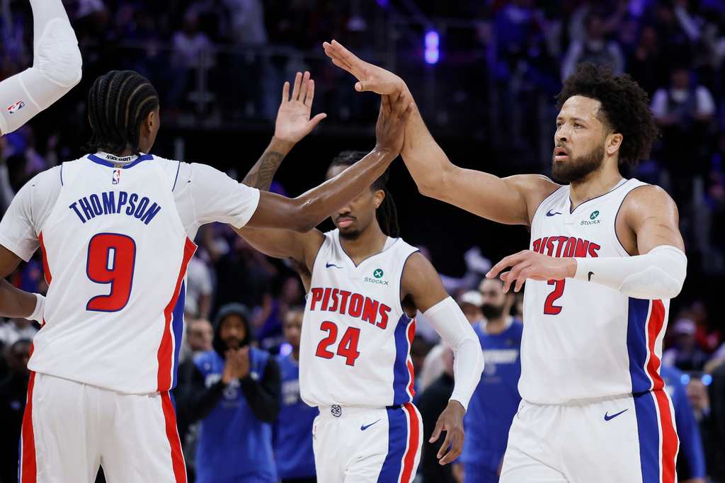 Detroit Pistons guard Cade Cunningham (2) celebrates with guards Ausar Thompson (9) and Daniss Jenkins (24) during the first half in Game 7 of a first-round NBA basketball playoffs series against the Orlando Magic, Sunday, May 3, 2026, in Detroit. (AP Photo/Duane Burleson)