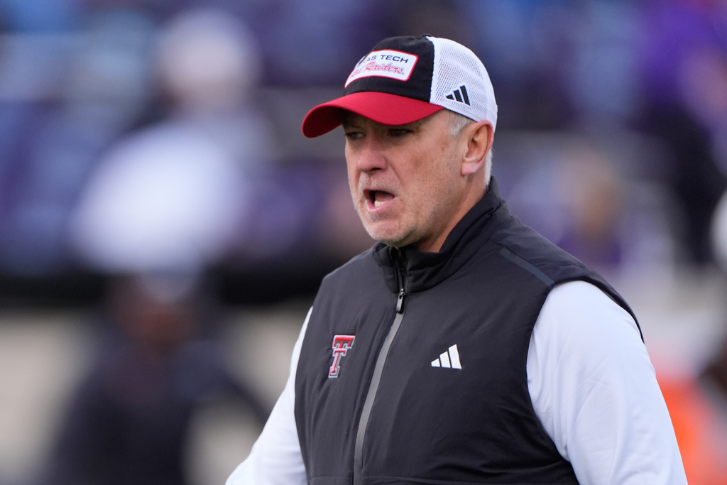 Texas Tech head coach Joey McGuire talks to his players before an NCAA college football game against Kansas State, Saturday, Nov. 1, 2025, in Manhattan, Kan. (AP Photo/Charlie Riedel)