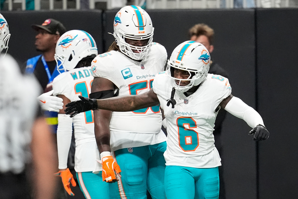 Miami Dolphins wide receiver Malik Washington (6) is congratulated after scoring a touchdown during the first half of an NFL football game against the Atlanta Falcons, Sunday, Oct. 26, 2025, in Atlanta. (AP Photo/Mike Stewart)