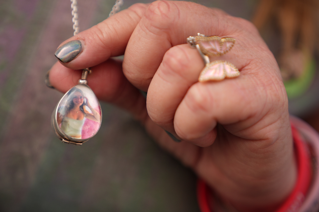 Victoria Hinks holds up a picture of her late daughter Alexandria "Owl" Hinks, who she says was a victim of social media platforms, outside the Spring Street Courthouse, Los Angeles Superior Court, in Los Angeles, Thursday, March 12, 2026. (AP Photo/Damian Dovarganes) ADDITION: to clarify opinion.