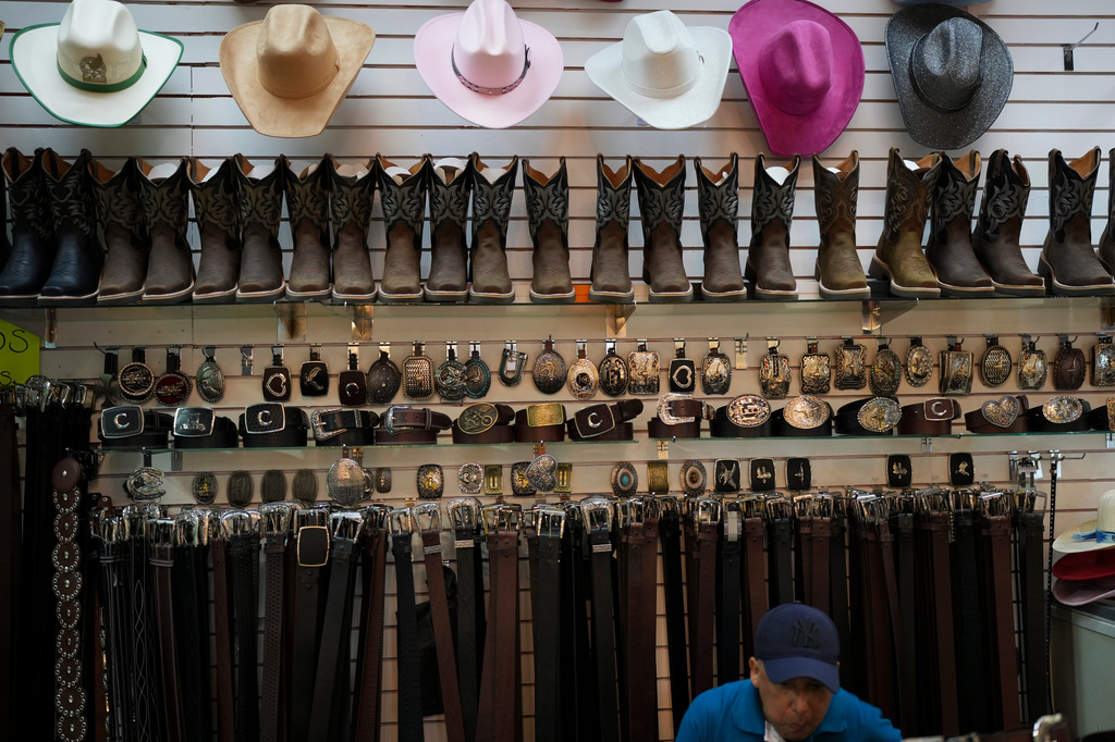 Cowboy boots, hats and belt buckles are on display at a store in Monterrey, northern Mexico, Tuesday, June 23, 2026. (AP Photo/Matias Delacroix)