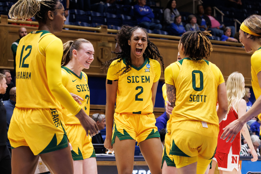 Baylor's Ella Brow (3), Kiersten Johnson (2), and Taliah Scott (0) celebrate after a play late in the second half of a game against Nebraska in the first round of the NCAA college basketball tournament, Friday, March 20, 2026, in Durham, N.C. (AP Photo/Ben McKeown)