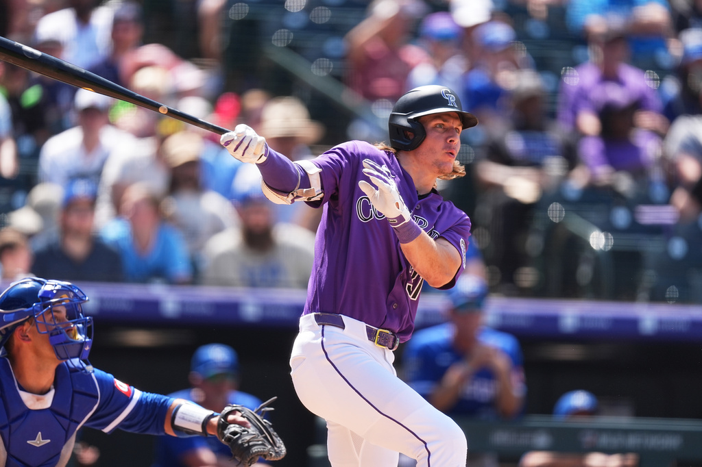 Colorado Rockies' Jake McCarthy follows the flight of his three-run home run off Kansas City Royals relief pitcher Aaron Bummer in the sixth inning of a baseball game Sunday, Aug. 2, 2026, in Denver. (AP Photo/David Zalubowski)