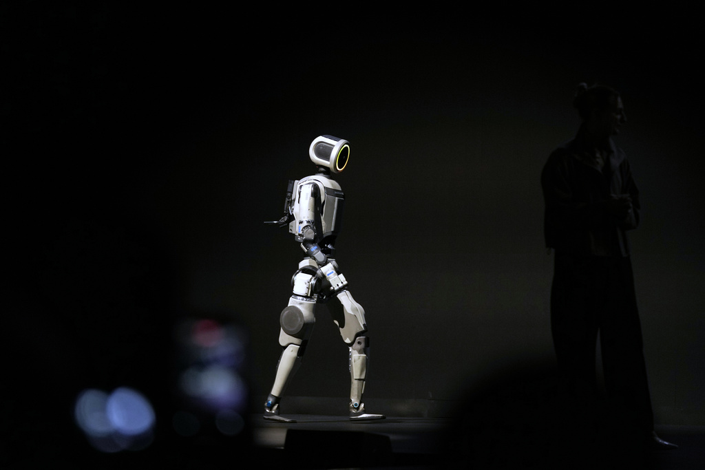 An Atlas robot walks across the stage during a Hyundai and Boston Dynamics news conference ahead of the CES tech show, Monday, Jan. 5, 2026, in Las Vegas. (AP Photo/Abbie Parr)