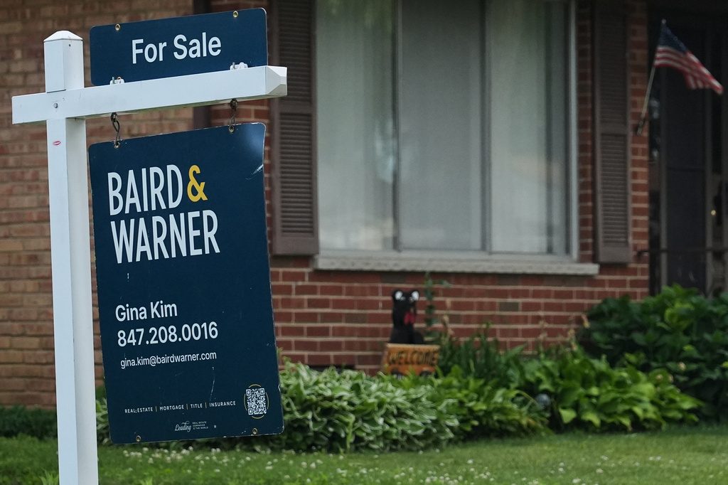 For sale sign is seen outside of a home in Wheeling, Ill., Monday, June 8, 2026. (AP Photo/Nam Y. Huh)