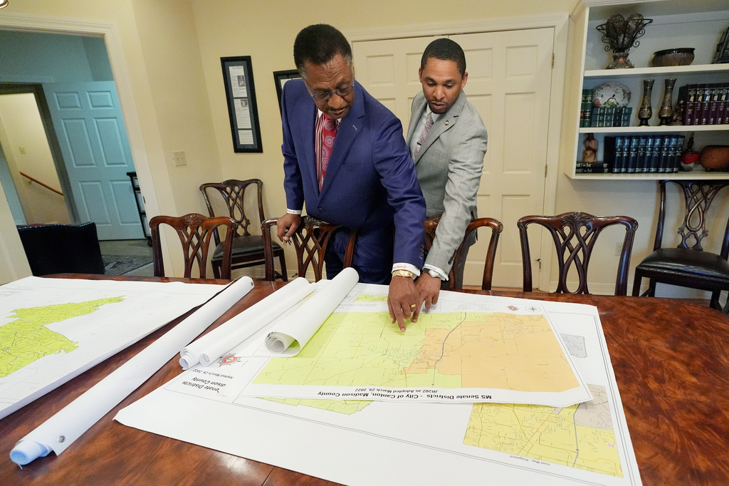 Attorney Edward Blackmon Jr., 78, a civil rights attorney and a former state representative, left, and his son, State Sen. Bradford Blackmon, D-Canton, review a 2022 redistricting map in their law office in Canton, Miss., Friday, May 1, 2026. (AP Photo/Rogelio V. Solis)