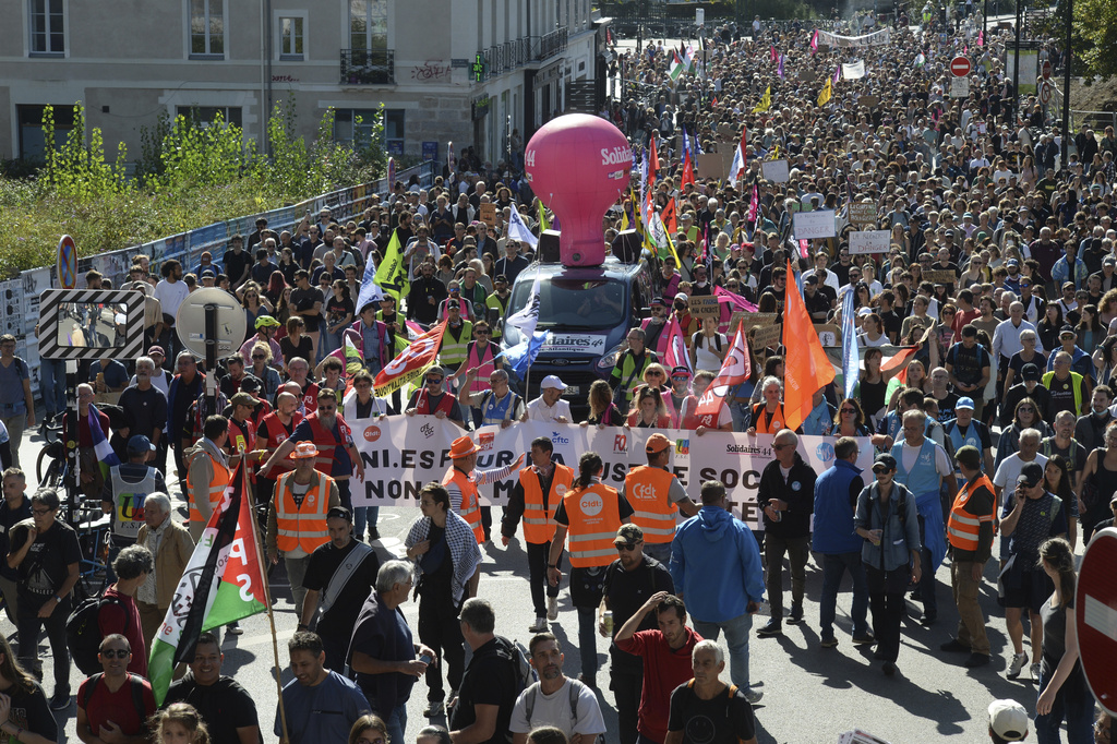 Demonstrators march during a protest called by major trade unions to oppose budget cuts, in Nantes, western France, Thursday, Sept. 18, 2025. (AP Photo/Mathieu Pattier)