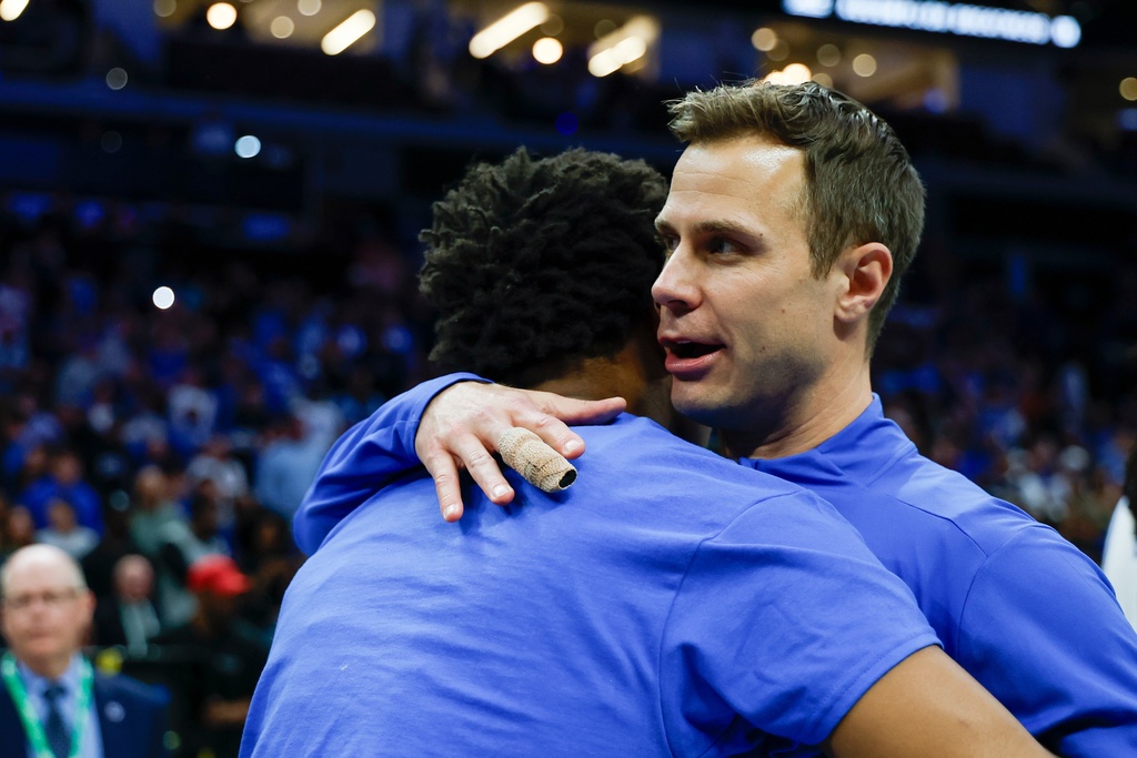 Duke head coach Jon Scheyer, right, hugs a player as Duke celebrates winning the championship of the Atlantic Coast Conference tournament in an NCAA college basketball game in Charlotte, N.C., Saturday, March 14, 2026. (AP Photo/Nell Redmond)