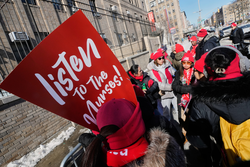 Striking nurses walk a picket line outside NewYork Presbyterian Hospital, in New York, Monday, Feb. 9, 2026. (AP Photo/Richard Drew)