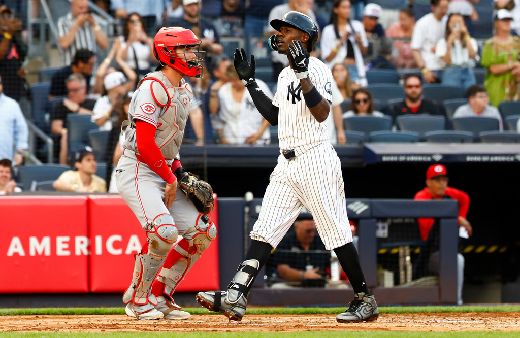 New York Yankees' Jazz Chisholm Jr., right, reacts in front of Cincinnati Reds catcher Tyler Stephenson, left, after hitting a home run during the second inning of a baseball game, Friday, June 19, 2026, in New York. (AP Photo/Noah K. Murray)