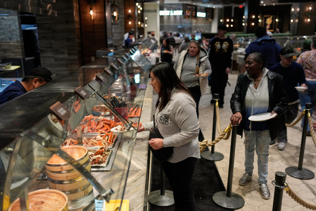 FILE - People are served food at the A.Y.C.E Buffet in the Palms resort-casino Wednesday, Jan. 28, 2026, in Las Vegas. (AP Photo/John Locher, File)