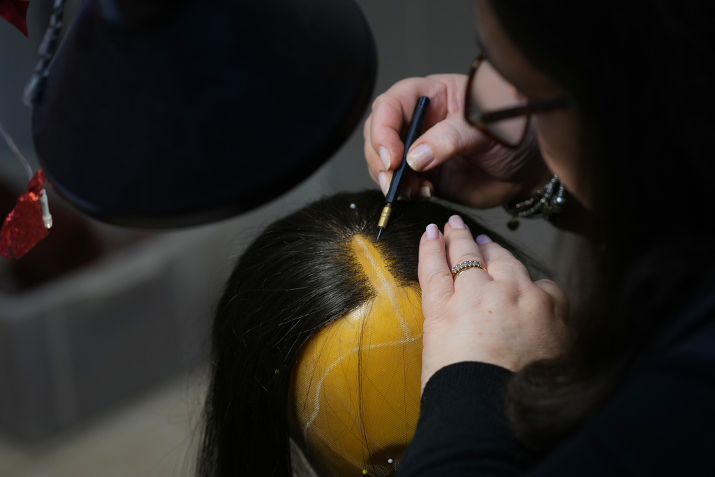 A wig receives final touches ahead of the dress rehearsal of Dmitri Shostakovich's Lady Macbeth of the Mtsensk District at La Scala Opera House in Milan, Italy, Thursday, Dec. 4, 2025. (AP Photo/Antonio Calanni)