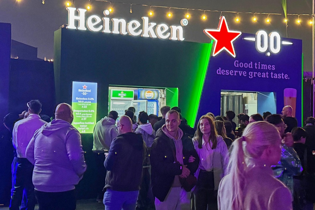 Festivalgoers gather near food and beverage stands, including a booth serving nonalcoholic beer, during the Soundstorm music festival in Riyadh, Saudi Arabia, Thursday, Dec. 11, 2025. (AP Photo/Baraa Anwer)