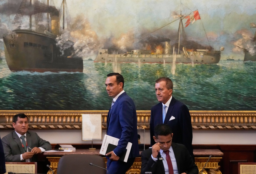 Peru's interim President Jose Jeri, center, arrives to Congress speak to lawmakers in Lima, Peru, Wednesday, Jan. 21, 2026. (AP Photo/Martin Mejia)