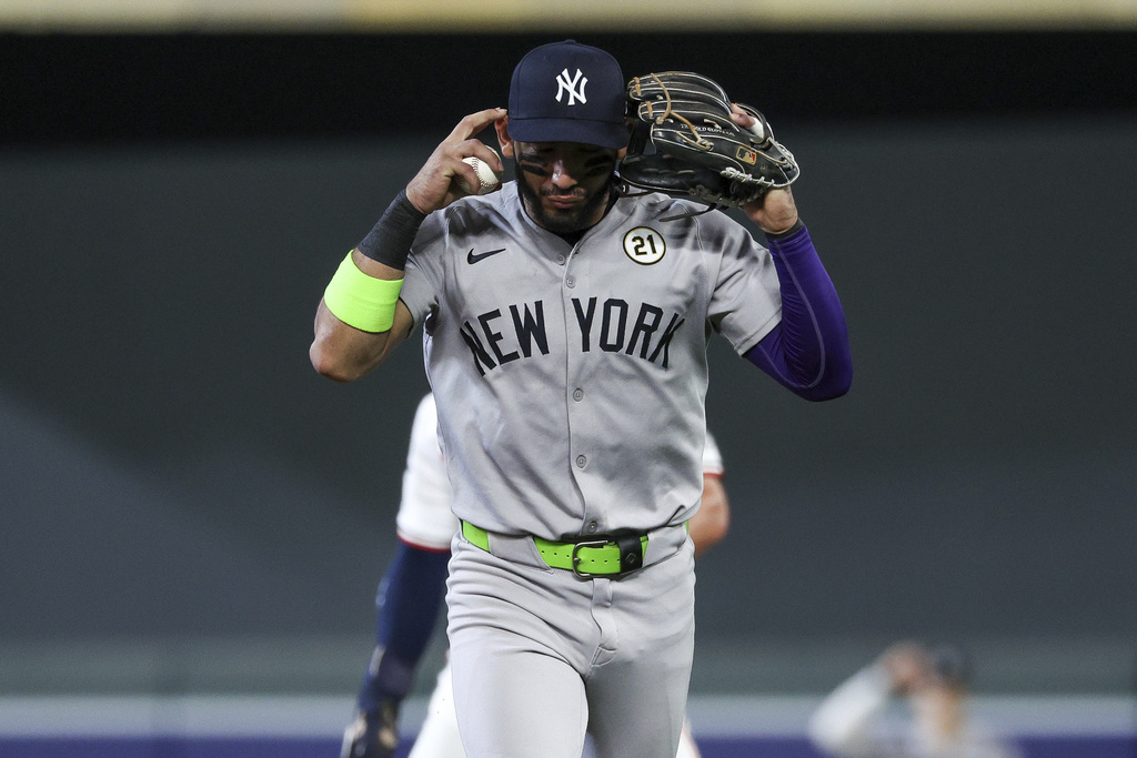 New York Yankees shortstop José Caballero gestures for a review during the sixth inning of baseball game against the Minnesota Twins, Monday, Sept. 15, 2025, in Minneapolis. (AP Photo/Matt Krohn)