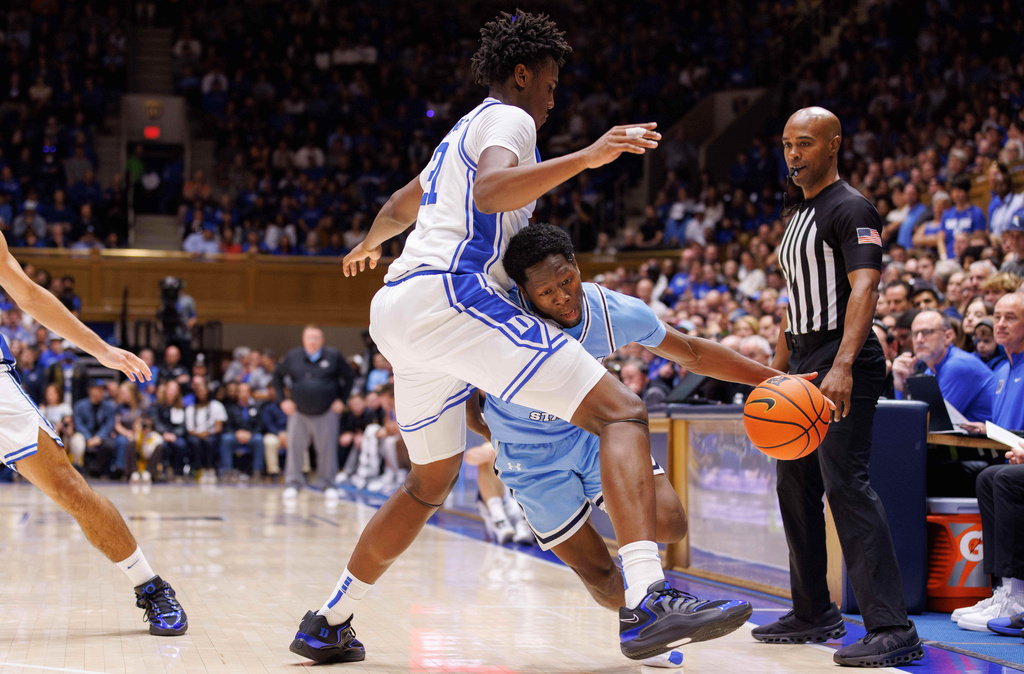 Indiana State's Xavier Hall, right, drives as Duke's Patrick Ngongba II (21) defends during the first half of an NCAA college basketball game in Durham, N.C., Friday, Nov. 14, 2025. (AP Photo/Ben McKeown)