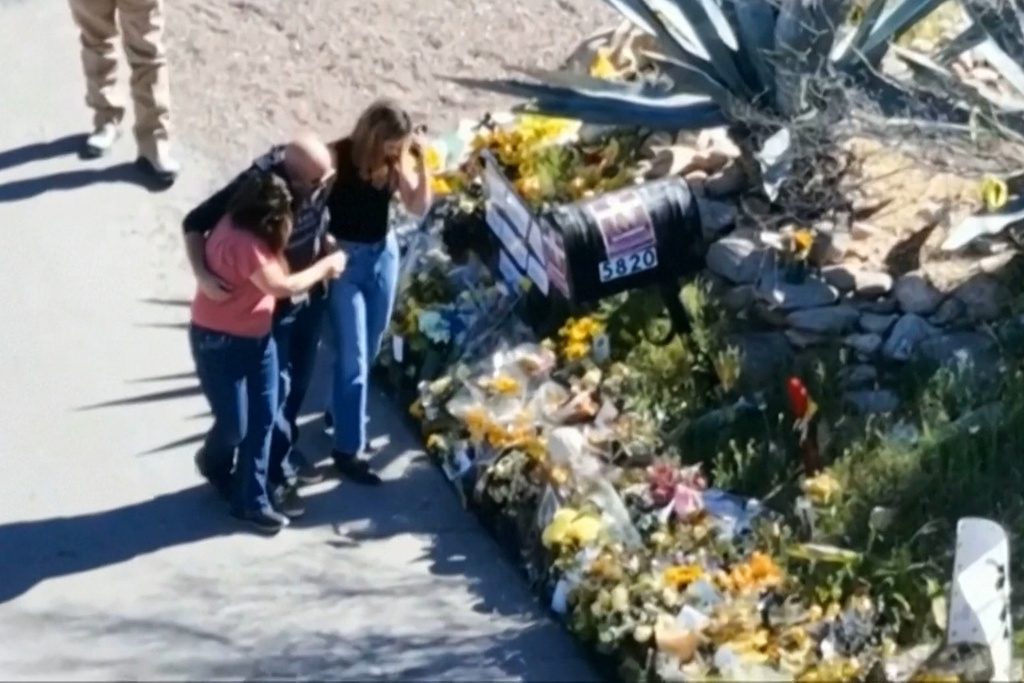 This image made from video provided by FOX News Digital shows Savannah Guthrie, right, her sister Annie Guthrie, left, and her brother-in-law Tommaso Cioni, Monday, March 2, 2026, visiting a tribute to their mother Nancy Guthrie. (FOX News Digital via AP)