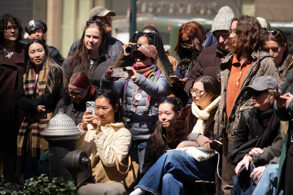 Visitors take photos of an American woodcock as it pauses along its spring migration route at Bryant Park in New York, Wednesday, April 8, 2026. (AP Photo/Emily Wang Fujiyama)