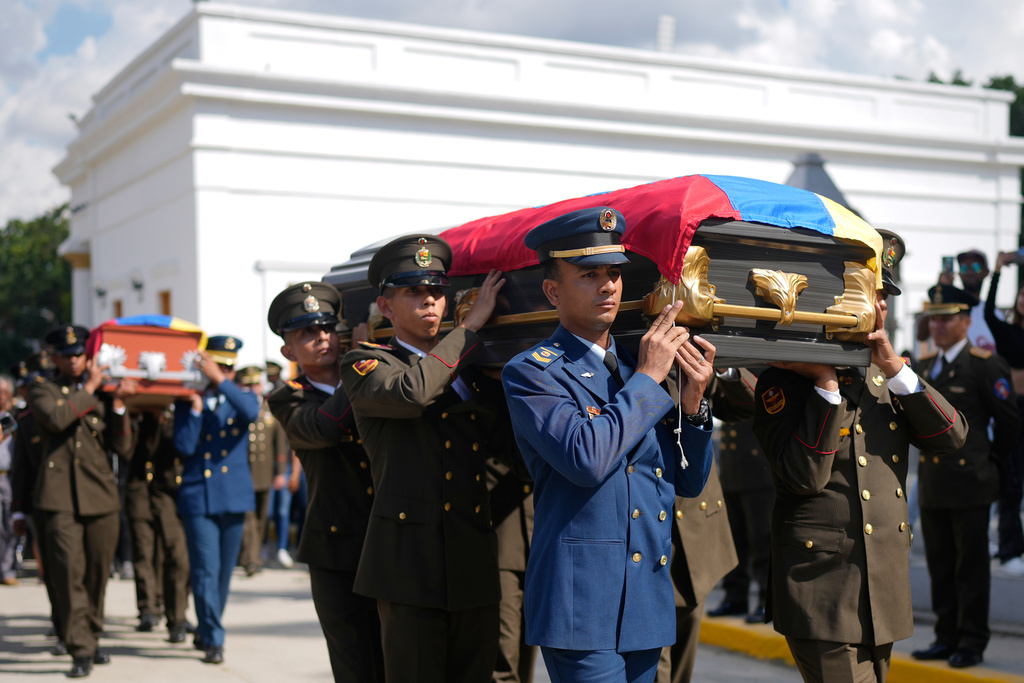 Military personnel carry the coffins of soldiers killed in the U.S. capture of Venezuelan President Nicolas Maduro and his wife, during a funeral in Caracas, Venezuela, Wednesday, Jan. 7, 2026. (AP Photo/Ariana Cubillos)