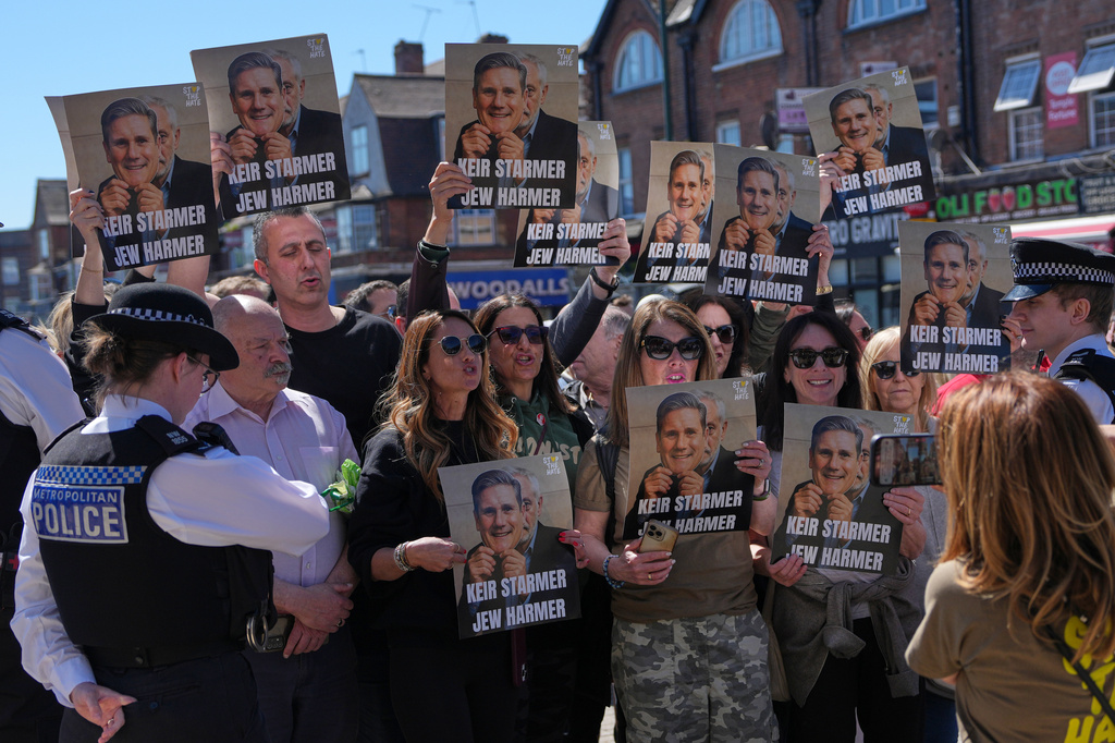 Protesters hold posters near the scene where two people were stabbed yesterday in the Golders Green neighbourhood, that has a large Jewish community, in London, Thursday, April 30, 2026.(AP Photo/Alastair Grant)