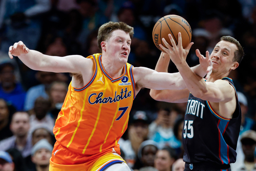 Charlotte Hornets guard Kon Knueppel (7) battles Detroit Pistons forward Duncan Robinson for the ball during the second half of an NBA basketball game in Charlotte, N.C., Friday, April 10, 2026. (AP Photo/Nell Redmond)
