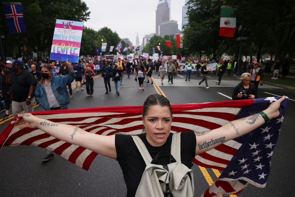 FILE - Demonstrators march down Benjamin Franklin Parkway during the "No Kings" protest, June 14, 2025, in Philadelphia. (AP Photo/Yuki Iwamura, File)