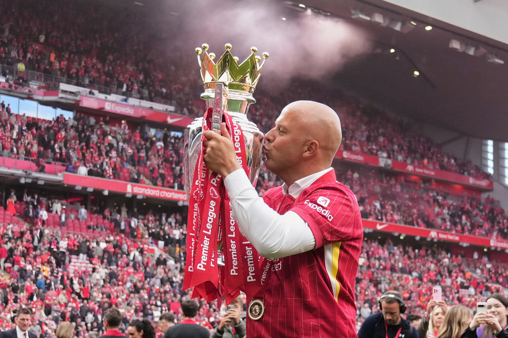 FILE - Liverpool's manager Arne Slot kisses the winner's trophy as he celebrates after the English Premier League soccer match between Liverpool and Crystal Palace at the Anfield stadium in Liverpool, England, Sunday, May 25, 2025. (AP Photo/Jon Super, File)