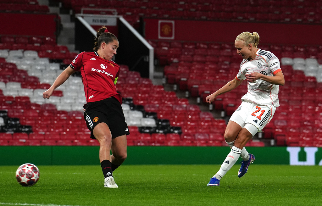 Bayern Munich's Pernille Harder, right, scores their side's first goal of the game during the Women's Champions League match between Manchester United and Bayern Munich in Manchester, England, Wednesday, March 25, 2026. (Martin Rickett/PA via AP)