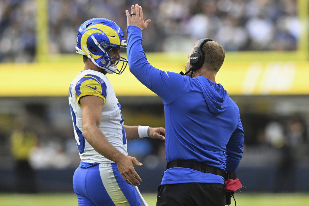 Los Angeles Rams quarterback Stetson Bennett IV (13) and head coach Sean McVay celebrate after a touchdown against the Dallas Cowboys during the first half of an NFL preseason football game, Saturday, Aug. 9, 2025, in Inglewood, Calif. (AP Photo/Wally Skalij)