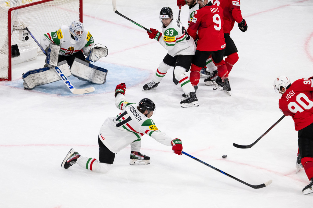 Switzerland's Roman Josi, right, scores the opening goal during the 2026 IIHF Men's Ice Hockey World Championship preliminary round group A match between Switzerland and Hungary in Zurich, Switzerland, Saturday, May 23, 2026. (Andreas Becker/Keystone via AP)