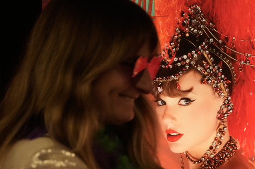 Jenni Boyer stands near a poster of Taylor Swift before the official release of Swift's new album, "The Life of a Showgirl," at the AMC Metreon in San Francisco, Friday, Oct. 3, 2025. (AP Photo/Jeff Chiu) Jenni Boyer stands near a poster of Taylor Swift before the official release of Swift's new album, "The Life of a Showgirl," at the AMC Metreon in San Francisco, Friday, Oct. 3, 2025. (AP Photo/Jeff Chiu)