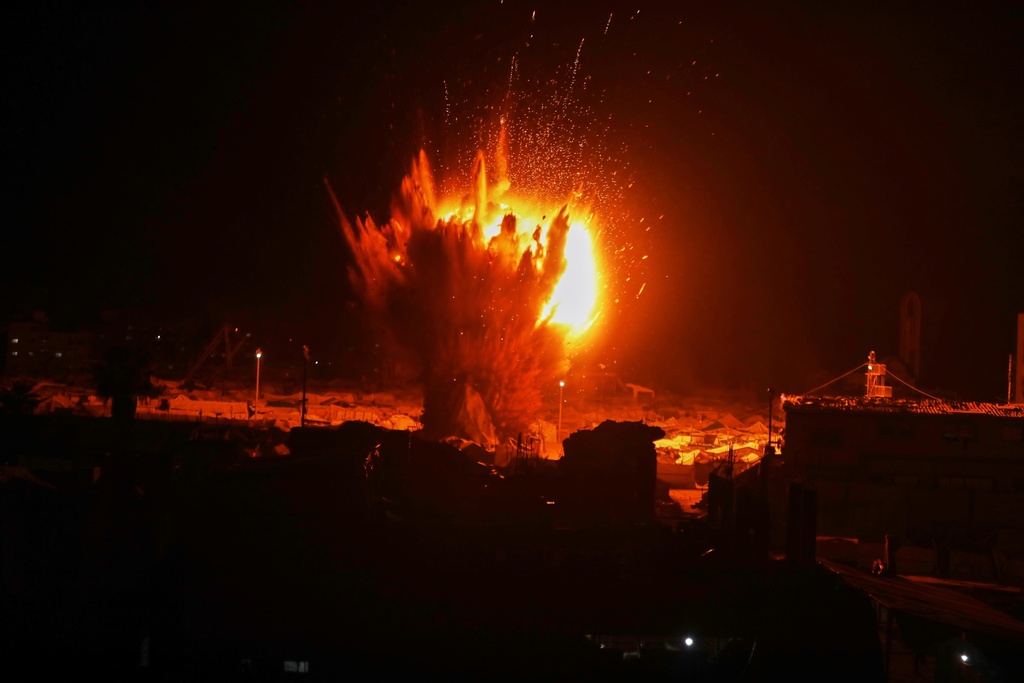 An Israeli army strike explodes next to a tent camp after residents were given a warning to evacuate before the strike in Gaza City, Wednesday, March 11, 2026. (AP Photo/Yousef Al Zanoun)