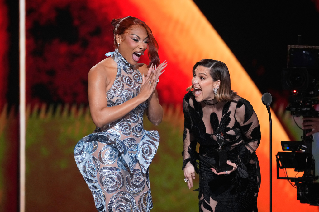 Megan Thee Stallion, left, presents the award for best performance by an actress in a featured role in a musical to Shoshana Bean for "The Lost Boys" during the 79th Tony Awards on Sunday, June 7, 2026, at Radio City Music Hall in New York. (Photo by Charles Sykes/Invision/AP)