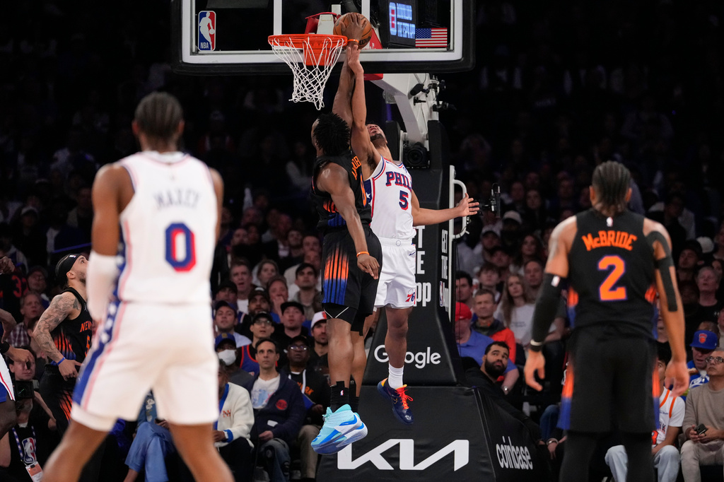 New York Knicks forward Og Anunoby, center left, blocks Philadelphia 76ers guard Quentin Grimes (5) during the first half of Game 2 in a second-round NBA basketball playoffs series, Wednesday, May 6, 2026, in New York. (AP Photo/Yuki Iwamura)