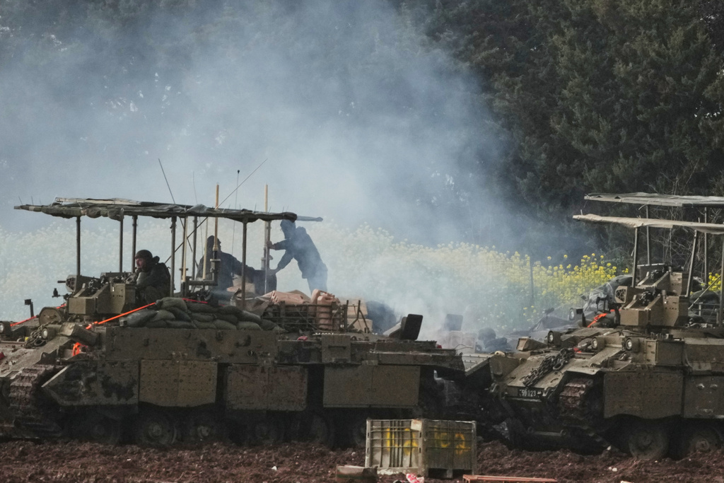 Israeli soldiers atop an APC in northern Israel near the border with Lebanon, Saturday, March 21, 2026. (AP Photo/Ariel Schalit)