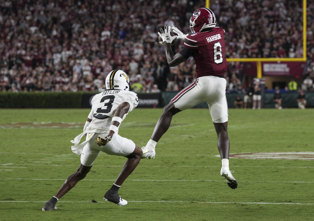 South Carolina wide receiver Nyck Harbor (8) catches a pass over Vanderbilt cornerback Kolbey Taylor (3) during the first half of an NCAA college football game Saturday, Sept. 13, 2025, in Columbia, S.C. (AP Photo/David Yeazell)