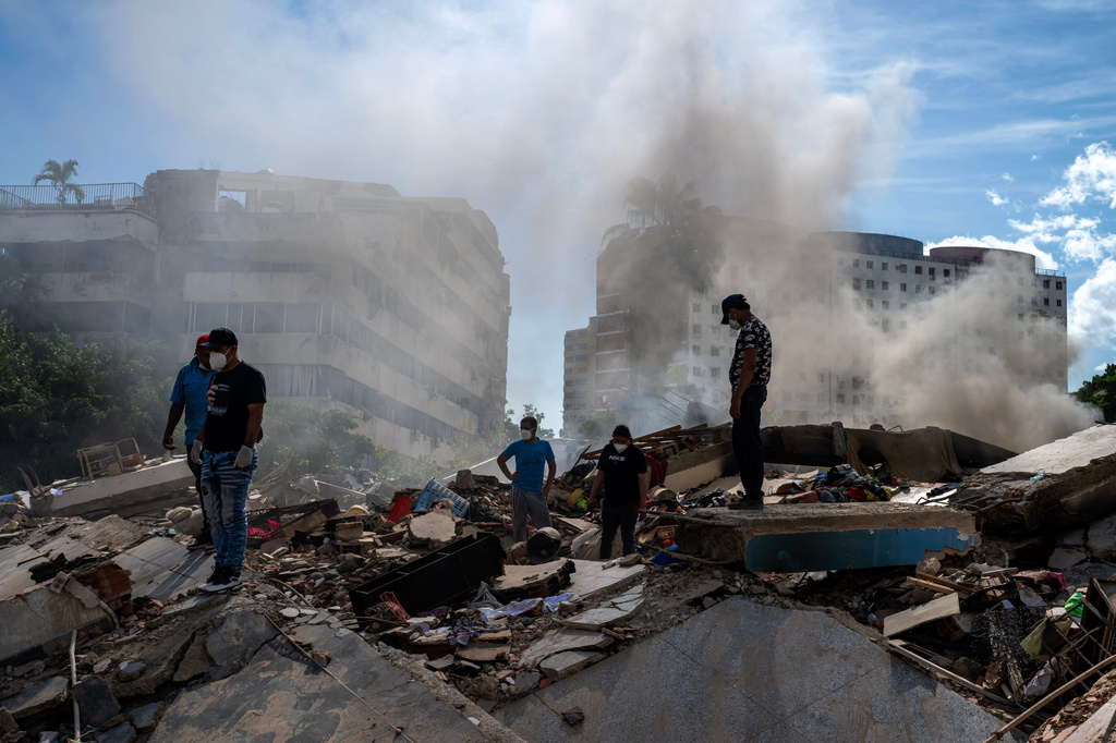 Rescue workers and volunteers stand on collapsed buildings during the search for earthquake survivors in La Guaira, Venezuela, Sunday, June 28, 2026. (Photo by Miguel Medina/Pool Photo via AP)