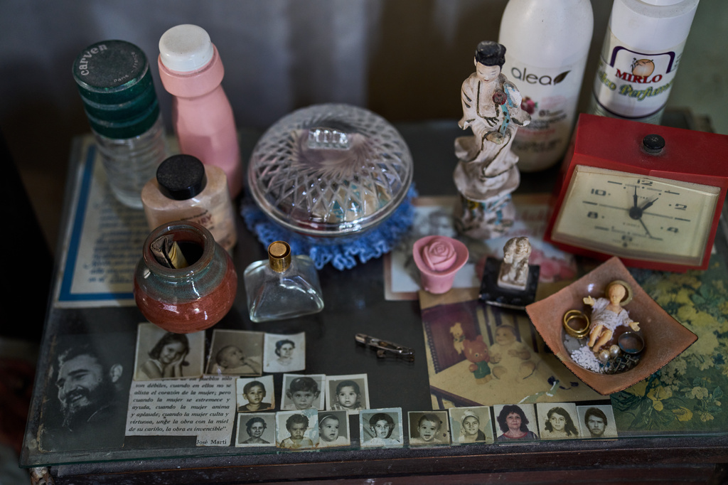 A photo of the late Cuban President Fidel Castro sits alongside photos of Mercedes Lopez Rey’s family on a bedside table at the 83-year-old’s home in Old Havana, Cuba, Wednesday, Feb. 19, 2025. (AP Photo/Ramon Espinosa)